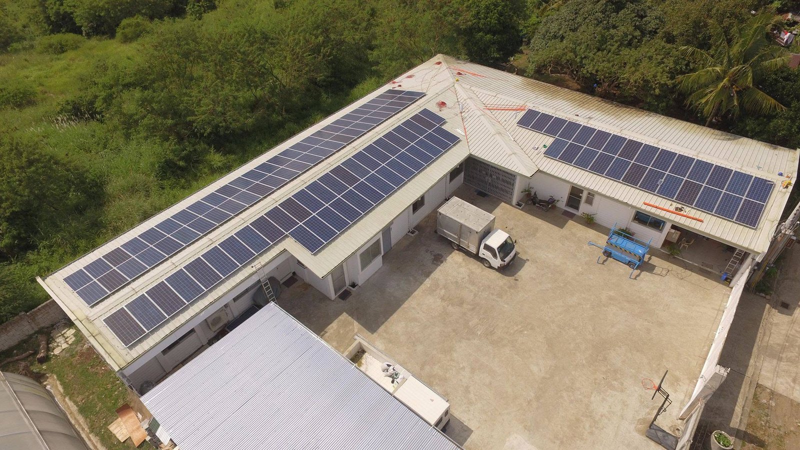 Aerial view of a large rooftop solar array on a commercial building